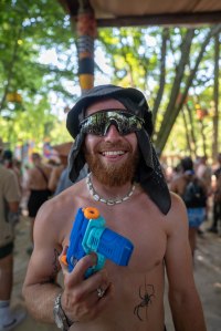 Man at Boomtown holding a plastic you gun