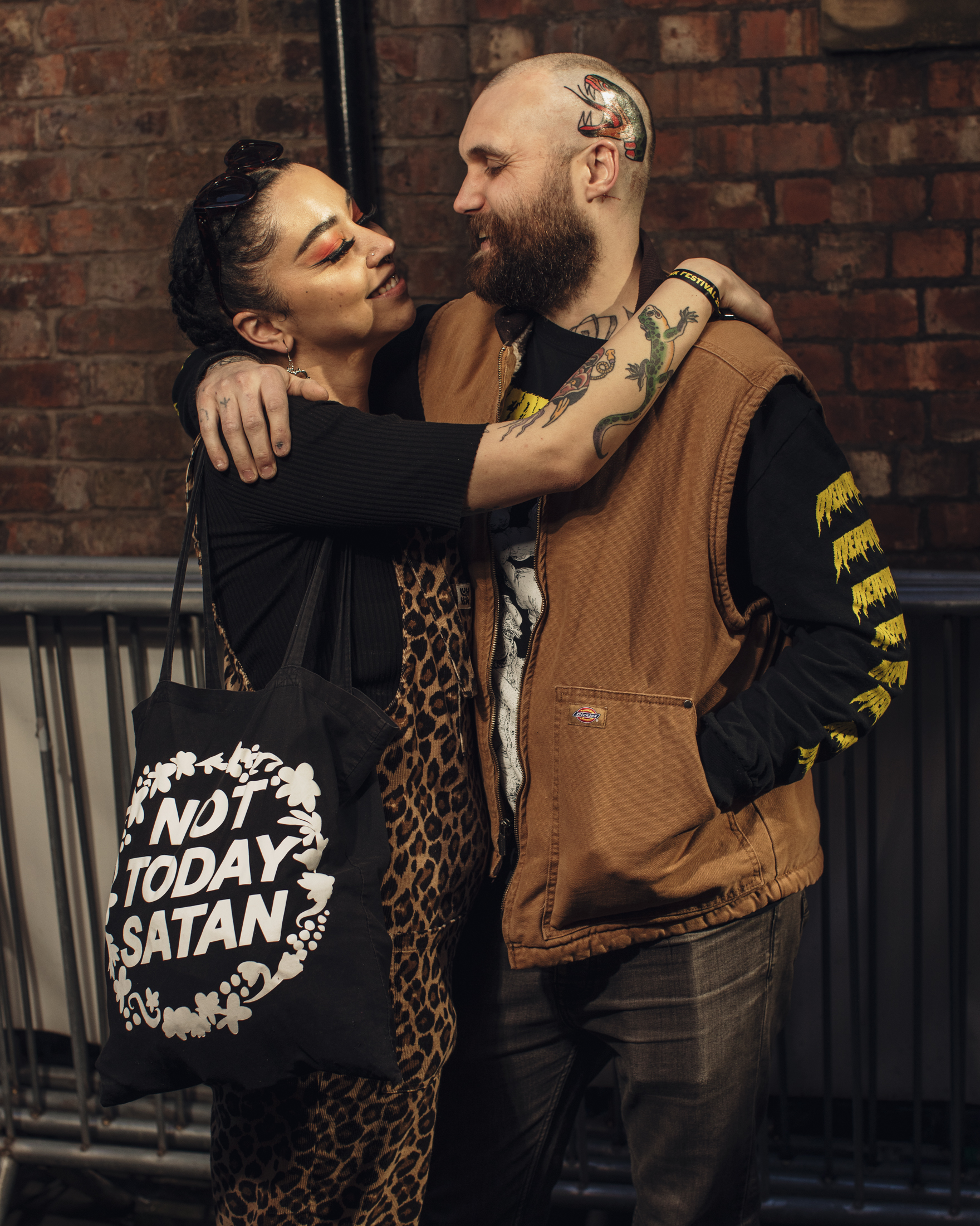 A woman in a cheetah print overall with a tote that says